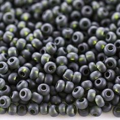 black seed beads with green tips