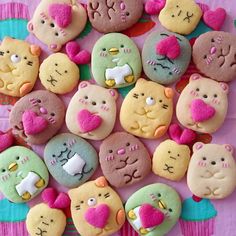 there are many decorated cookies in the shape of cats