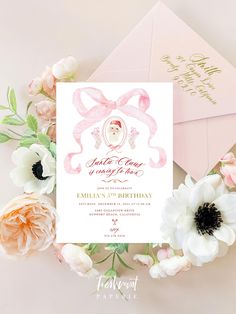 a pink and gold birthday party with an envelope, flowers, and greeting card on it