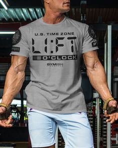 089. Lift O'Clock Motivational Workout T-Shirt Gray Moisture-wicking Athleisure T-shirt, Athletic Heather Moisture-wicking T-shirt For Gym, Gray Athleisure T-shirt With Letter Print, Casual Letter Print T-shirt For Training, Athletic Heather Workout Tops With Short Sleeves, Gray Athleisure T-shirt For Training, Gray Sportswear T-shirt For Gym, Gray Athletic Fit T-shirt For Training, Athletic Heather Workout T-shirt