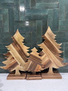 three wooden christmas trees sitting on top of each other