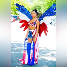 a woman dressed in an american flag outfit and wings is posing for the camera with her hands on her hips