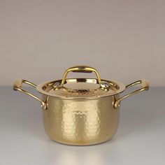 a large gold pot with two handles