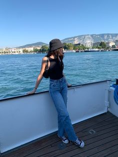 a woman leaning on the edge of a boat