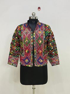 Indian Vintage Mirror Work Jacket Women Handmade Embroidery Mirror Work Festival Fashion Wear Jacket, Vintage Banjara Overcoat Jacket Handmade Women Cotton Designer Jacket, This Jacket Is Made By Hand And Embroidered By Local Artisans, This Jacket Have No Closer  Long Sleeves And Vibrant Colors, Must Add In Your Wardrobe Product Detail Material :- Cotton Embroidered Length :- 21 inch Sleeve Length :- 20 Inch NOTE : Product color may slightly vary due to photographic lighting sources or your moni Festive Multicolor Outerwear With Intricate Embroidery, Festive Multicolor Intricately Embroidered Outerwear, Festive Multicolor Outerwear With Floral Embroidery, Festive Long Sleeve Outerwear With Mirror Work, Traditional Multicolor Outerwear For Festivals, Multicolor Motif Outerwear For Festivals, Traditional Outerwear With Multicolor Embroidery And Motifs, Traditional Long Sleeve Outerwear With Mirror Work, Festival Multicolor Outerwear With Floral Embroidery