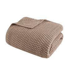 a brown blanket is folded on top of a white background and it's made out of knitted material