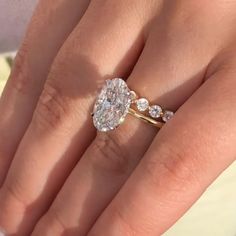 a woman's hand with a ring on it and a diamond in the middle