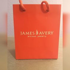 an orange bag with the name james avery on it