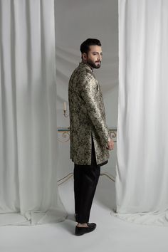 Upgrade your style with our Black and Gold Prince Coat. Made from luxurious brocade material, this front open coat exudes royalty. Paired with an Indian raw silk kurta pajama, it's the perfect ensemble for any formal event. Elevate your look and make a statement with this unique and elegant piece. 3-Piece Suit Elegant Raw Silk Sherwani With Traditional Drape, Elegant Raw Silk Sherwani Straight Kurta, Elegant Sherwani In Raw Silk With Straight Kurta, Elegant Designer Wear Sherwani With Straight Kurta, Elegant Raw Silk Sherwani With Dabka Detailing, Elegant Straight Kurta Bandhgala For Party, Elegant Silk Sherwani For Eid, Unstitched Elegant Straight Kurta Sherwani, Elegant Unstitched Sherwani With Straight Kurta