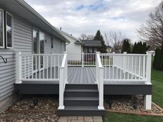 a white deck with steps leading up to the house