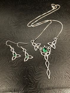 I will fabricate this unique and gorgeous set for you, in sterling silver, and using lab-created Emeralds. This is a lovely Celtic inspired wedding set which will enhance your wedding theme! I fabricated the necklace using 5 sterling silver Trinity knots with a center 8mm round Emerald. I've then solder attached a 16 inch sterling silver box chain to either jumping on opposing ends. The total length of the necklace is 18 inches long, but if you want it shorter, please let me know and I can adjus Hand Set Sterling Silver Pendant Jewelry, Traditional Sterling Silver Jewelry Sets With Elegant Design, Fine Jewelry Hand Set Sterling Silver Sets, Fine Jewelry Sets In Sterling Silver, Fine Jewelry Sets In Sterling Silver Hand Set, Handcrafted Sterling Silver White Gold Jewelry Sets, Silver Emerald Jewelry Sets For Gift, White Gold Sterling Silver Jewelry Sets With Gemstones, Hand Set White Gold Sterling Silver Jewelry Sets