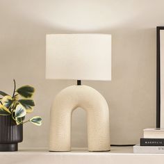 a lamp and some books on a shelf