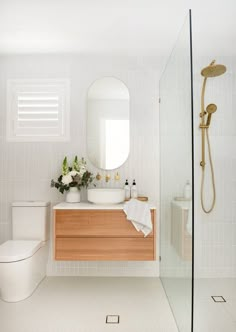 a bathroom with a sink, toilet and shower in it's center area is shown