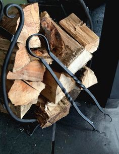 a pile of wood sitting on top of a metal stand