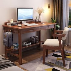 a desk with a computer and chair in front of a window, next to a bed