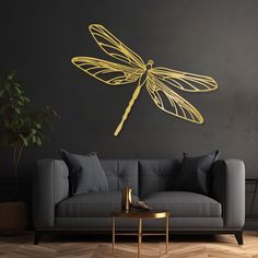 a living room with a couch, coffee table and large yellow dragonfly on the wall