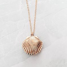 This is a beautiful gold plated vintage style (but brand new) scallop seashell locket on a 14k Gold Filled chain. This is great for a small photo inside. It's just like the classic lockets we used to have way back when! It's ADORABLE!!!All necklaces come beautifully and simply packaged in an eco-friendly kraft box and twine ready for gifting.About the jewelry:• The seashell locket is approximately an inch wide and high.• The scallop charm is plated with gold.• All components of the necklace are Vintage Gold Shell As A Gift, Vintage Gold Shell As Gift, Vintage Gold Shell Gift, Gold Shell With Lobster Clasp As Gift, Vintage Shell Jewelry For Gift, Vintage Shell Necklace As Gift, Vintage Shell Jewelry For Gifts, Vintage Shell-shaped Necklaces For Gifts, Vintage Shell For Gift