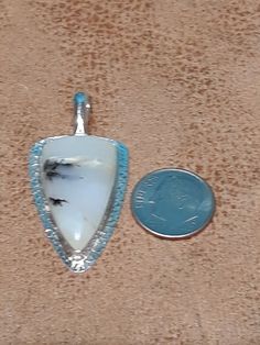 One of a kind, handcrafted, Scenic Peruvian Opal pendant. Measures about 44mm X 21mm. CHAIN NOT INCLUDED. Artisan Handmade Pendant Jewelry, Handmade Artisan Pendant Jewelry, Handmade Sterling Silver Arrowhead Necklace, Unique Healing Medallion Jewelry, Handmade Artisan White Jewelry, White Artisan Handmade Jewelry, Artisan Handmade White Jewelry, Bohemian Arrowhead Jewelry As Gift, Bohemian Arrowhead Jewelry As A Gift