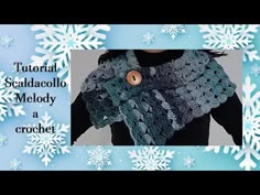 a crocheted scarf with buttons on it and snowflakes in the background