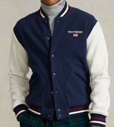 Brand new with tags Size: XXL Faux shearling baseball jacket Striped ribbed baseball collar.  Snapped placket. Long sleeves with striped ribbed cuffs. "Polo Sport Ralph Lauren" logo and American Flag embroidered at the left chest.  Two front waist angled pockets. Striped ribbed hem. Shell: 100% polyester. Collar, cuffs, and hem: 91% cotton, 8% nylon, 1% elastane. Dry clean. Model is 6'1"/185 cm and wears a size medium. Winter Cotton Varsity Jacket With Button Closure, Long Sleeve Cotton Track Jacket With Patchwork, Cotton Long Sleeve Track Jacket With Patchwork, Cotton Patchwork Long Sleeve Track Jacket, Cotton Varsity Outerwear With Long Sleeves, Cotton Long Sleeve Varsity Outerwear, Winter Varsity Long Sleeve Track Jacket, Sporty Long Sleeve Patchwork Outerwear, Navy Cotton Sport Coat For Winter