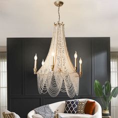 The body of this chandelier is made of high quality crystal.Like a huge white trumpet flower hanging from the ceiling, this Bohemian style chandelier features petticoat-shaped iron frame trimmed with candle-shaped bulb stems with little dish cups. Numerous strands of crystal beads woven together, and the extra part of the bottom is well arranged like valances hanging freely from the champagne colored frame. Extra large size, ideal for high-ceiling rooms. like living room, staircase, big bedroom, Duplex Villa, Chandelier Boho, Boho Candle, Crystal Light Fixture, Trumpet Flower, Flower Hanging, Hall Lighting, Big Bedrooms, Luxury Restaurant