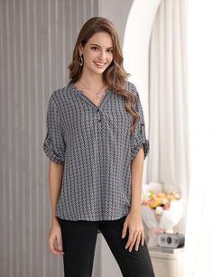 This elegant women's pullover blouse features a sleek geometric graphic print, elevating its timeless sophistication. A lovely Mandarin collar forms a perfect V-neck - wonderful to showcase your collection of necklaces. The soft curvature of the neckline creates a beautiful design aesthetic. The 3-button half opening adds comfort and style to this pull-on women's shirt. Accent leggings, jeans and business slacks for casual comfort all day. Choose to leave the 3/4 cuffed sleeve down or boost to a short-sleeve style by buttoning the tab. Details: *100% rayon  *Machine washable *V-neck blouse with transition from 3/4 to short sleeve Spring Blouse With Geometric Pattern, Spring Black Blouse With Geometric Pattern, Elegant Long Sleeve Tops With Geometric Pattern, Elegant Long Sleeve Top With Geometric Pattern, Cuffed Sleeve, Geometric Graphic, Design Aesthetic, V Neck Blouse, Mandarin Collar