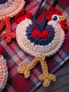 crocheted chicken ornaments on a plaid tablecloth