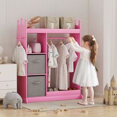 Description: KORIMEFA kids closet measures 44.1*33.5*13.4, providing ample storage space for the children's costume dressing. You can hang all types of dresses or costumes on the kids clothing rack, store toys and boxes on the top shelf, keep decorations in the three storage cubbies, and place shoes in the bottom section. Additional hooks are perfect for hanging bags and jewelry accessories. This Kids dress up rack with mirror is a Great Gift Idef Birthdays, Christmas, Or Just As a Surprise. Fea Toddler Dress Up Area Pretend Play, Toddler Costume Closet, Dress Up Stations Walmart, Kid Clothing Shelves, Dress Up Clothes Storage Ikea, Dressing Up Kids Storage, Dress Up Storage Out Of Furniture, Corner Dress Up Station, Doll Clothes Storage Hack