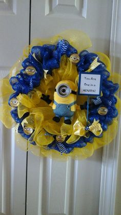 a yellow and blue wreath with a minion on it