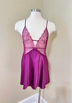 Vintage Victoria's Secret Satin Maroon/Deep Wine  Chemise Slipdress Short Nightie. Floral sheer mesh lace bodice with eyelash trim. Deep V neck with criss-cross, adjustable spaghetti straps, metal sliders. Soft satin polyester 97% and elastane 3%. Slightly flared skirt, nice drape. Chemise  is in excellent vintage condition with no stains or defects noted.  Size Large, relaxed fit. Check measurements below for accurate sizing.  Bust 36" Underbust 32-33" Waist about 38" Length from top of bust to hem 28" not including strap. Please see all photos of this Victoria's Secret Maroon/Wine Chemise Slip dress  for complete description. Note computer monitors may vary in display of color. Please convo with questions or for additional photos. This shop does not accept returns or exchanges. Please co Women's Nightgowns, Pajama Robe, Satin Slip, Satin Slip Dress, Lace Bodice, Flared Skirt, Fit Check, Flare Skirt, Criss Cross