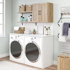 a washer and dryer sitting in a room next to each other with towels hanging on the rack