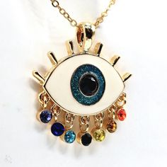 Add Some Bohemian Charm To Your Jewelry Collection With This Beautiful Eye-Catching Pendant Necklace From Harleyscrazedcreations. The Necklace Features A Colorful Evil Eye Ball With Rainbow Tear Drop Lashes, Adding A Touch Of Art And Beauty To Your Outfit. The Pendant Is Made Of Enamel And Glass, Iron, And Zinc Alloy. The Lobster Closure And Adjustable Features Ensure That The Necklace Fits Comfortably Around Your Neck. With Seven Gemstones And A Glass Main Stone, This Necklace Is Perfect For Th Multicolor Metal Pendant Charm Necklaces, Multicolor Evil Eye Necklace For Gift, Multicolor Evil Eye Necklace As Gift, Multicolor Charm Necklaces For Gifts, Multicolor Charm Necklace For Gift, Eye-catching Dangle Jewelry For Gifts, Party Multicolor Charms Necklaces, Multicolor Metal Charm Necklace With Adjustable Chain, Multicolor Pendant Charm Necklace As Gift