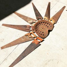 several rusty scissors are laying on the ground with holes cut out for them to be used as gadgets