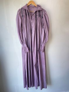 Vintage Purple Victorian Nightgown. Lace-trimmed nightgown with bow details and puffy sleeves that make you feel like you're in a haunted 1920s mansion. The collar has black details that bring out the lacey designs. In good vintage condition with a few missing buttons (sold as is). Fits like a S/M. Feels like cotton/linen. Approx. Measurements: Underarm to underarm: 18" Length: 55" Victorian Style Long Sleeve Prairie Dress For Daywear, Victorian Prairie Dress With Long Sleeves For Daywear, Peasant Style Victorian Dress For Daywear, Regency Style Long Sleeve Vintage Dress For Daywear, Vintage Dresses For Spring Night, Vintage Night Dresses For Spring, Long Sleeve Lace Trim Dress For Night, Long Sleeve Dresses With Lace Trim For Night, Vintage Lace Trim Dresses For Loungewear