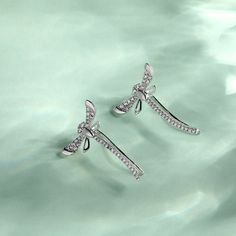 These sterling silver dragonfly earrings are symbolic of a lighter and brighter outlook on life - reminding us to live life to the fullest. This piece is undeniably shimmering and powerfully eye-catching - a dragonfly weaving through an earlobe is rarely seen! They make a delicate and meaningful gift for a loved one. Love life with our cute dragonfly climber earrings!Carat Weight: 0.748 ctStone Size: 1,1.2,1.3 mmStone Type: Jeulia® StoneNumber of Stones: 64 Stone Shape: RoundStone Color: Diamond Elegant Sterling Silver Dragonfly Earrings, Elegant Dragonfly Earrings With Ear Wire, Elegant Dragonfly Jewelry With Ear Wire, Silver Fine Jewelry Ear Climbers As Gift, Silver Ear Climbers Fine Jewelry Gift, Elegant Silver Ear Climbers As Gift, Elegant Silver Ear Climbers For Gifts, Cute Dragonfly, Live Life To The Fullest