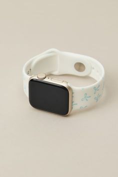 an apple watch band with blue and white flowers on the side, sitting on a table