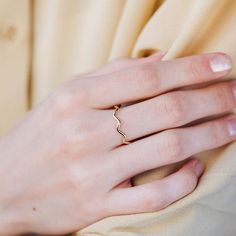 A dainty gold ring with zig zag pattern. A stacking gold ring for women, minimal and simple that adds glam to every outfit. This stacking wavy band can be used a an alternative wedding band as well. The best Mother's Day gift. 100% handcrafted with love!D E T A I L S● Metal: 14K solid gold, 14K white gold or 14K rose goldR I N G ∙ S I Z I N GFor General Reference:● we use standard US Ring Sizing● an average women's ring finger is size 6-7● each ring is custom made upon order, in any desired size Modern Twist 14k Gold Stackable Rings, 14k Gold Filled Midi Rings For Anniversary, Yellow Gold Stackable Rings With Simple Design, 14k Gold Stackable Rings With Modern Twist As Gift, Elegant White Gold Wavy Jewelry, Elegant Wavy White Gold Jewelry, Minimalist 14k Gold Wavy Jewelry, 14k Gold Midi Rings For Anniversary With Modern Twist, Minimalist 14k Gold Wavy Ring