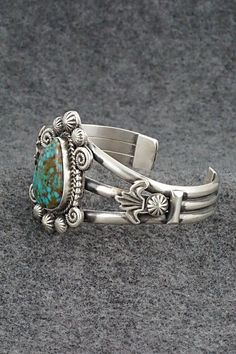 This stunning Kingman turquoise and sterling silver bracelet was made by Navajo silversmith Rosita Calladitto. The back is signed R Calladitto and stamped Sterling.Size: 5 5/8" (will fit up to a 6 3/4" wrist)Gap: 1 1/8"Width: 1 5/8"Cuff Width: 1/2"Free shipping on all orders! We ship with USPS and always include tracking. All orders ship within a day of payment.Returns are accepted up to 30 days after you receive your order. Just send us a message. Our shop offers cash back or store credit. The Elegant Turquoise Bracelet With Inlay, Elegant Turquoise Inlay Bracelet, Artisan Turquoise Engraved Bracelets, Collectible Bohemian Turquoise Bracelets, Artisan Turquoise Engraved Bracelet, Bohemian Turquoise Bracelets Collectible, Bohemian Turquoise Collectible Bracelets, Collectible Bohemian Turquoise Bracelet, Southwestern Patina Bangle Jewelry