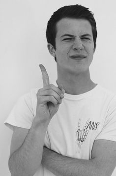 black and white photograph of a young man making a funny face with his finger to the side