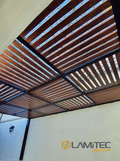 the inside of a building with wooden slatted ceiling and logo for lamitec