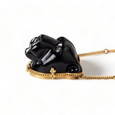 This glossy black Obsidian was hand-carved into a powerful, black panther and brought to life with sparkling Emerald eyes. This wild cat embodies grace and courage. We encased it in an 18k gold bezel with braided detail and prongs. Obsidian is considered to be a highly protective stone so wear it as a protection amulet. One of a kind. Technical Details Metal: 18k yellow goldRainbow Obsidian: 40.52 cts. Emerald EyesChain: can be worn at 16" and 18"Pendant Size: 24 x 22mmClosure: lobster claspHand Luxury Black Spinel Jewelry, Luxury Black Spinel Jewelry With Polished Finish, Luxury Carved Necklaces, Luxury Carved Pendant Jewelry, Luxury Black Spinel Jewelry Gift, Luxury Black Spinel Jewelry As Gift, Luxury Handmade Onyx Jewelry, Handmade Luxury Black Jewelry, Luxury Handmade Black Jewelry