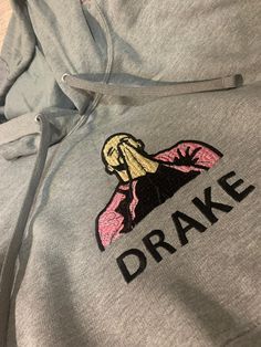 Drake embroidered hoodie. Long sleeve, grey, cotton hoodie. Made to order and can customize the color of Drake's jacket. Size S - 3X Specify size and color of jacket preferred in notes. Drake Hoodie, Drake Photos, Drizzy Drake, Trendy Outfit Inspo, Fits Clothes, Embroidered Hoodie, Simple Trendy Outfits, Really Cute Outfits, Cute Simple Outfits