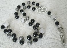 "This beautiful wiccan rosary has black obsidian beads, onyx beads, sterling silver plated bead caps, sterling silver plated filigree beads, pewter silver pentacle and a pewter silver goddess. A lovely way to pray to the Goddess and meditate. 20\" long." Black Gothic Jewelry With 8mm Beads, Spiritual Obsidian Beaded Jewelry, Mystical Black Jewelry For Healing, Black Mystical Jewelry For Halloween, Bohemian Halloween Jewelry With Round Beads, Gothic Black Round Bead Jewelry, Adjustable Gothic Jewelry With Round Beads, Black 8mm Beads Jewelry For Festival, Black Gemstone Beads Jewelry For Festival