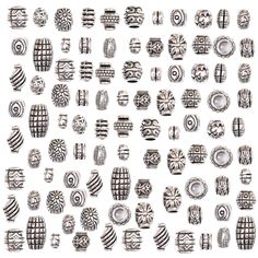 an assortment of silver colored beads and rings on a white background, all in different shapes and sizes