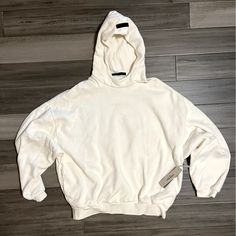 Cozy Cream Colored Hoodie With Logo On Front And Black Branded Tab On Hood. Brand New, Never Worn! White Hooded Sweater For Streetwear, White Sweater With Drawstring Hood For Streetwear, Comfy Hooded Sweatshirt With Drawstring, White Casual Hoodie With Ribbed Cuffs, Comfy Crew Neck Hoodie For Streetwear, Comfortable Hooded Sweatshirt With Adjustable Hood, Comfy Long Sleeve Hoodie With Adjustable Hood, Cozy Sweatshirt For Streetwear, Cozy Streetwear Sweatshirt With Adjustable Hood