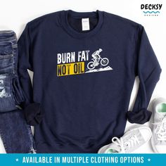 Are you a passionate cyclist and advocate for the environment? Our Cyclist Shirt for Men is the perfect choice for eco-conscious riders. With a powerful message featuring the words "BURN FAT NOT OIL," our shirt promotes a greener and healthier lifestyle. Whether you're cycling for fitness or commuting to work, our shirt lets you express your commitment to sustainability. Available in various styles like t-shirt, tank top, sweatshirt, and hoodie, you can ride in style while making a positive impa Graphic Cycling T-shirt With Crew Neck, Graphic Tee T-shirt With Crew Neck For Cycling, Graphic Tee With Crew Neck For Cycling, Casual Cotton T-shirt For Cycling, Casual Crew Neck T-shirt For Outdoor Activities, Sporty Crew Neck Top For Cycling, Crew Neck Cotton T-shirt For Cycling, Cotton Crew Neck T-shirt For Cycling, Healthier Lifestyle