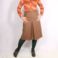 "Vintage Italian 70s Pure New Wool plaid front pleat skirt in beige S/M, Academia smart casual skirt 30s 40s style - A-shaped secretary, business, work, office, smart casual skirt - Similar to 30s and 40s style - Medium weight fabric, lined - Zip closure - High-waisted - Brand: Variable Firenze - 100% pure new wool, lining estimated viscose - Excellent mint vintage condition - Tag size I46, estimated S/M, please see exact measurements MORE vintage SKIRTS in my shop: https://www.etsy.com/shop/GoodGrooves?ref=simple-shop-header-name&listing_id=1308389865§ion_id=39276826 ✿ MEASUREMENTS (taken flat) ✿ 27.5\" / 70  cm length 15.5'' / 39.5 cm waist I have M in the waist (30''/ 76 cm) and L in the hips (41.5'' / 106 cm) - it was a slightly small fit. My height - 5'7 / 170cm. This is true vintage, Fitted Pleated Pencil Skirt For Fall, Brown Pleated Midi Skirt For Work, Vintage Brown Knee-length Skirt, Fitted Midi Pleated Skirt With Box Pleat, Fitted Box Pleat Midi Pleated Skirt, Classic Knee-length Skirt For Fall, Brown Pleated Skirt For Work, Fall Fitted Skirt With Box Pleat, Fitted Beige Bottoms With Accordion Pleats