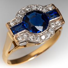 a blue and white diamond ring with two rows of diamonds around it