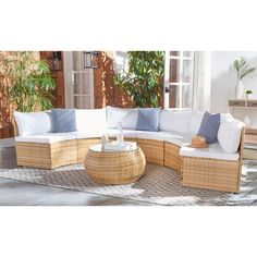 an outdoor living room with wicker furniture