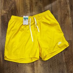 Mens Nike Woven Lined Flow Shorts It's Officially Shorts Season! Get In The Spirit With These Lightweight Woven Lined Flow Shorts From Nike Sportswear. Nike Embroidery At Hem Side Pockets Elastic Waistband With Adjustable Drawstring Back Pocket Inner Lining Lightweight Polyester Material Color Shown: Yellow Style: #Dm6829-731 Yellow Leisure Bottoms For Summer, Neon Yellow Sports Shorts For Summer, Yellow Sports Swim Trunks, Sporty Yellow Swim Trunks Short Length, Sporty Yellow Swim Trunks, Sporty Yellow Short Swim Trunks, Yellow Swim Trunks For Sports, Yellow Casual Short Swim Trunks, Casual Yellow Short Swim Trunks